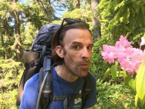 Sasha and beautiful pink flowers in the woods